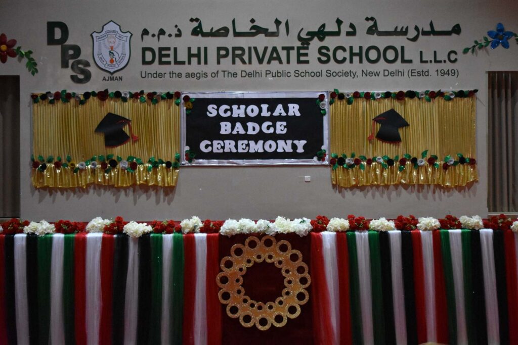Stage decorated for the Scholar Badge Ceremony at Delhi Private School Ajman